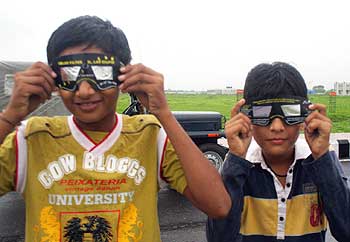 Children with solar eclipse spectacles at the Surat Airport