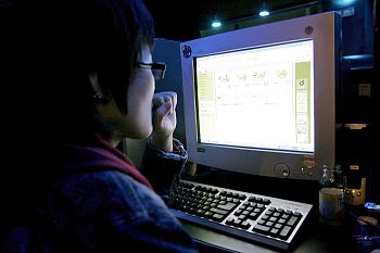A person surfs the Web at an Internet cafe in Seoul