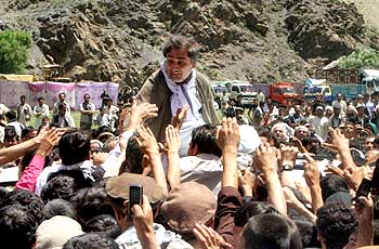 Afghanistan's presidential candidate Abdullah Abdullah is greeted by supporters while campaigning in Panjshir province.