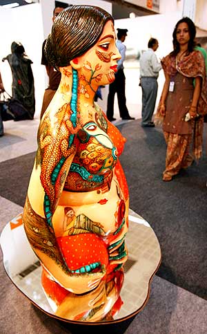 A visitor looks at contemporary art during the India Art Summit in New Delhi, August 23, 2008.
