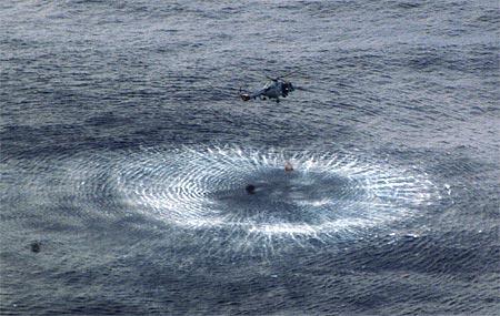 A Brazilian helicopter works to recover spotted debris from the crashed plane in Atlantic