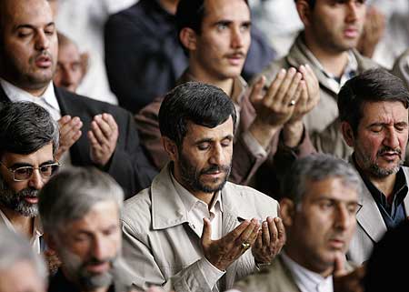 Iranian President Mahmoud Ahmadinejad (Centre) praying during Friday prayers at an university in Tehran
