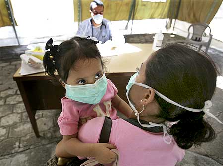 A doctor talks to a mother before testing her child in Nicaragua