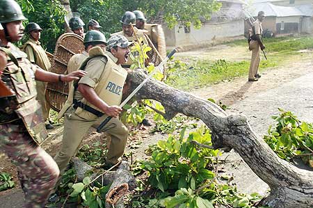 Police remove a roadblock set by the activists of People's Committee Against Police Atrocities at Bhimpur near Lalgarh