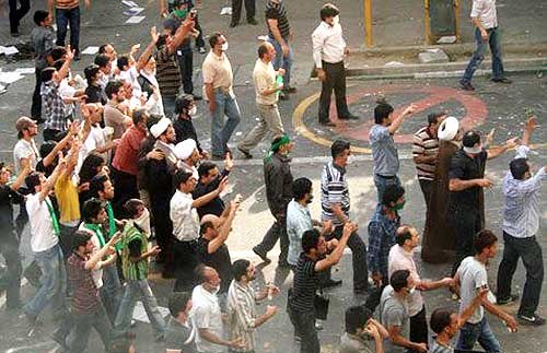 Protesters gesture on a street in Tehran in this undated photo uploaded onto Twitter