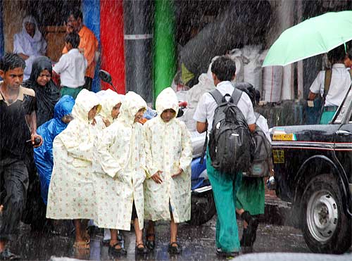 Shool children walking home in the rain