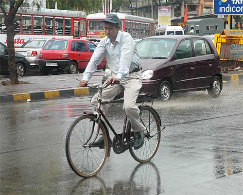 A cyclist caught in the monsoon shower