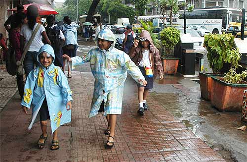 School children frolic in the rain