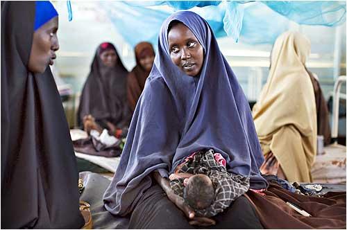 A Somali refugee woman holds her newborn infant in the maternity ward in a health clinic at Dagahaley camp in Dadaab in Kenya's northeastern province