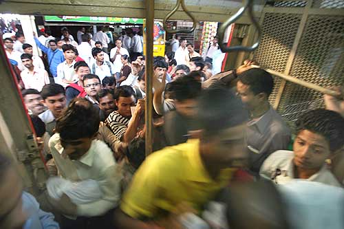Commuters rush into a suburban train