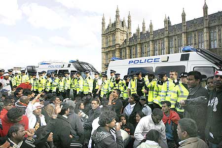 Pro-Tamil demonstrators face police after blocking a road in front of British Parliament on May 18