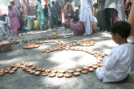 An Om sign made out of mud lamps at the Khir Bhawani shrine