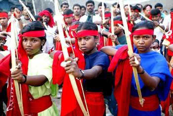 Naxals pose with bows and arrows during a rally in Kolkata