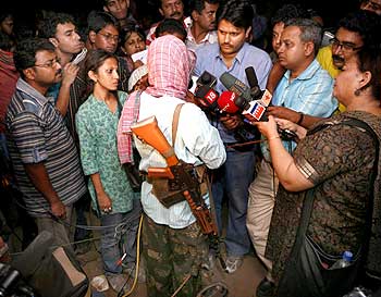 Maoist leader 'Kishenji', with back to camera, speaks to the media in Bholagara village, Bengal
