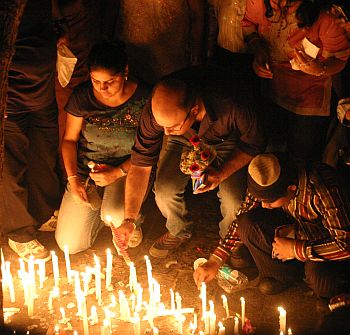 People light candles to pay their respects to those who lost their lives during the attacks.