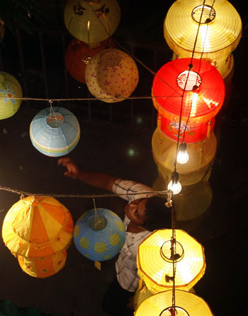 A man looks at colourful Diwali lamps in Mumbai