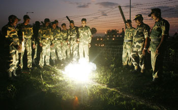BSF soldiers set off fire crackers to celebrate Diwali at the India-Bangladesh border on the outskirts of Siliguri