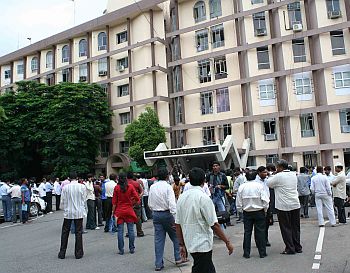 Media persons wait outside the secretariat, awaiting information on the CM