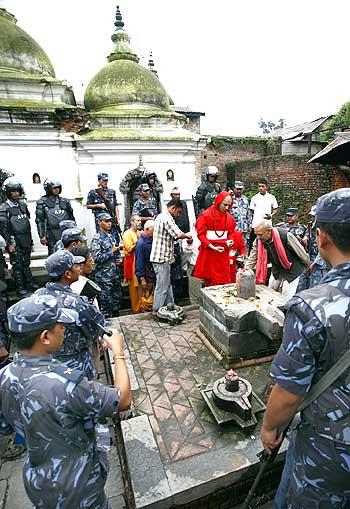 Raghavendra Bhatt (in red) offers prayers at Pashupatinat temple.