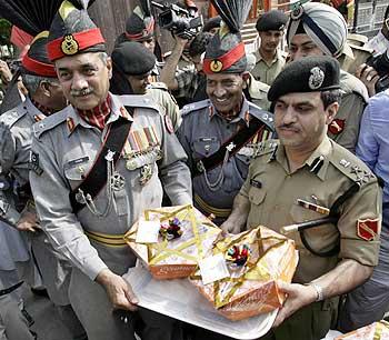 Pakistan Rangers greet Border Security Force troopers at the Wagah border