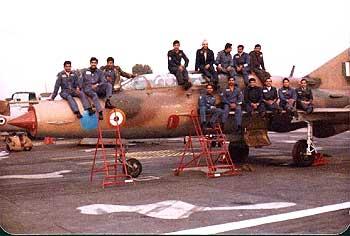 MP, extreme left,  with pilots atop a MiG-21 UB trainer aircraft