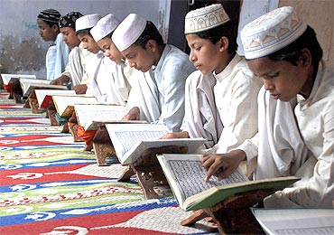Muslim children read the Quran at a madrassa