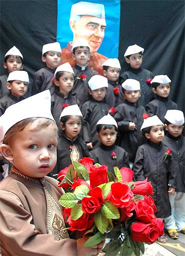 School children dressed as Chacha Nehru take part in a fancy dress competition