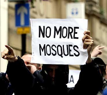 A man holds up a banner during a demonstration by the English Defence League in Birmingham