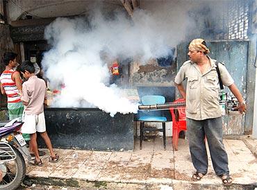 A municipal worker uses a fogging machine to combat rise in Malaria in Mumbai