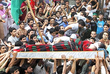 Men carry the body of Mohammad Iqbal, a Kashmiri youth killed during the protests