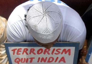 An activist holds a placard during a peace rally