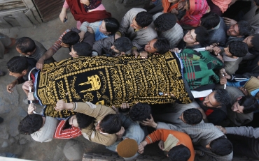 People carry the body of Khursheed Ahmad Parray, who was killed during an attack by militants in Khan Sahib, Kashmir