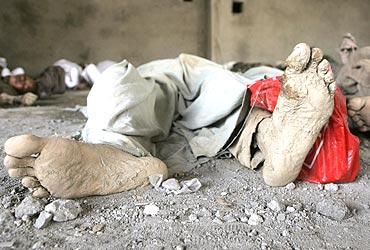 Bodies of flash flood victims lie inside a shop in Leh