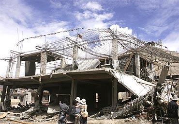 The rubble of houses destroyed by flash floods in Leh