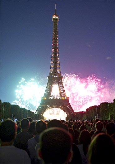 The Eiffel Tower is illuminated during the traditional Bastille Day fireworks display in Paris