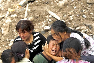 People mourn their missing relatives in the landslide-hit Zhouqu county of Gannan, China