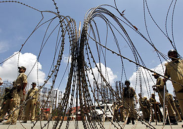 Policemen at a barricade in Srinagar