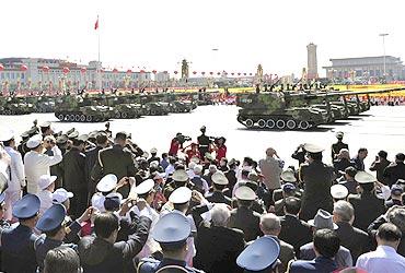 People's Liberation Army tanks roll pass Tiananmen Square in Beijing