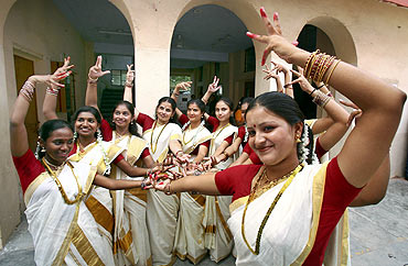Traditionally dressed women dancers perform during the Onam festivities
