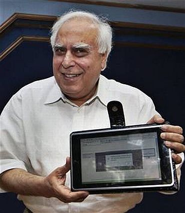 Human Resource Development Minister Kapil Sibal shows off India's first low cost tablet PC