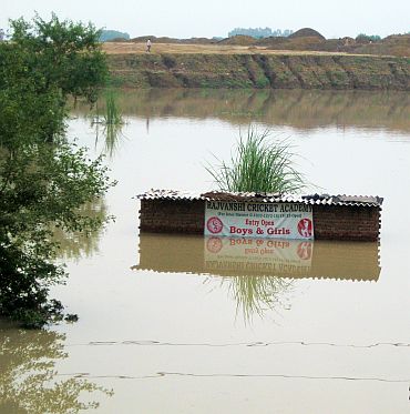 Only the board of the cricket academy remains over water