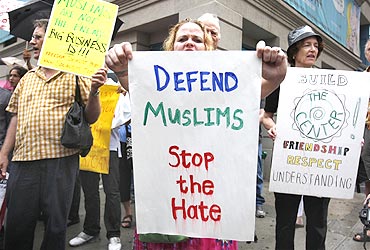 A woman holds a sign in support of the proposed Muslim cultural centre and mosque near Ground Zero