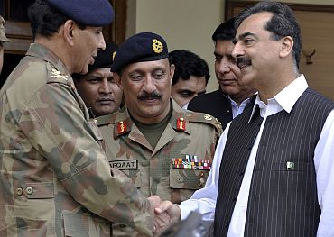Pakistan's PM Gilani shakes hands with Army Chief Kayani at army headquarters in Multan