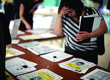 A woman browses for job openings at a fair in Los Angeles