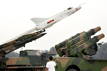 A boy looks at old PLA missile launchers on display at the China Aviation Museum