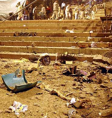 Onlookers stand at the site of a blast in Varanasi on Tuesday.