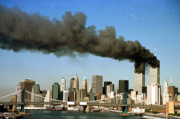The towers of the World Trade Center pour smoke shortly after being struck by hijacked commercial airplanes in New York on September 11, 2001