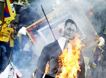 Tibetan exiles burn an effigy of Chinese Premier Wen Jiabao during a protest against his visit to In