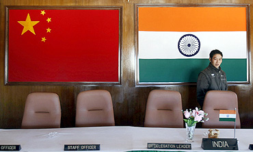 A man walks into a conference room used for meetings between military commanders of China and India