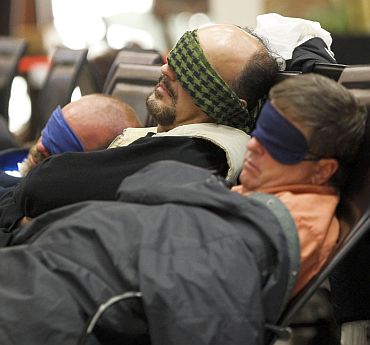 Travellers sleep at the main terminal of Frankfurt's airport